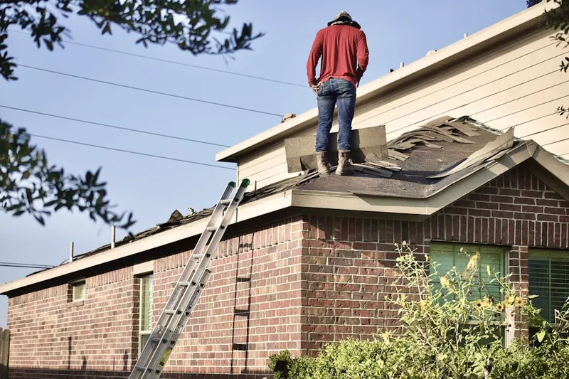 Professional roofer working on a residential roof in Hales Corners
